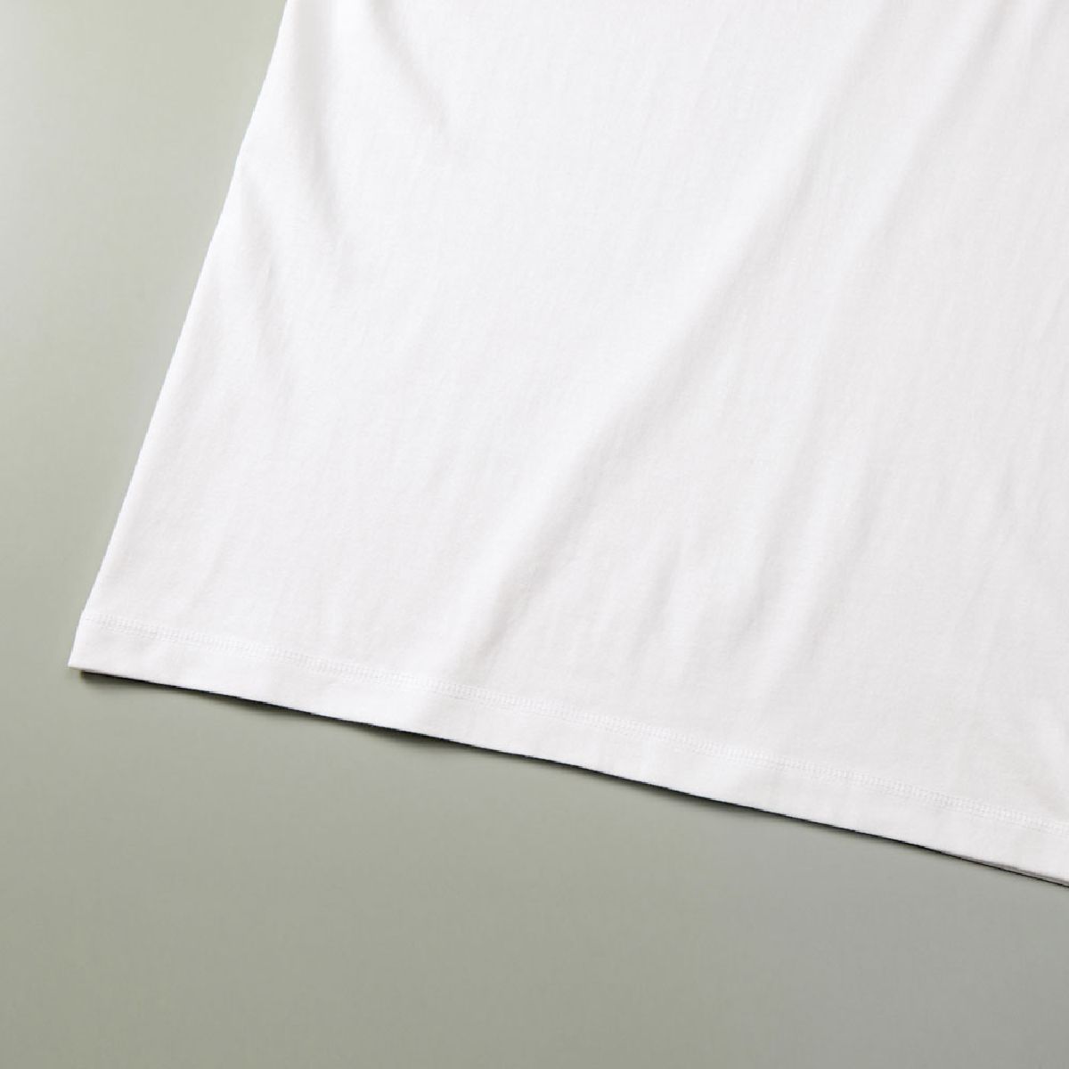 Seamless construction, hem finished with triple-needle stitching.