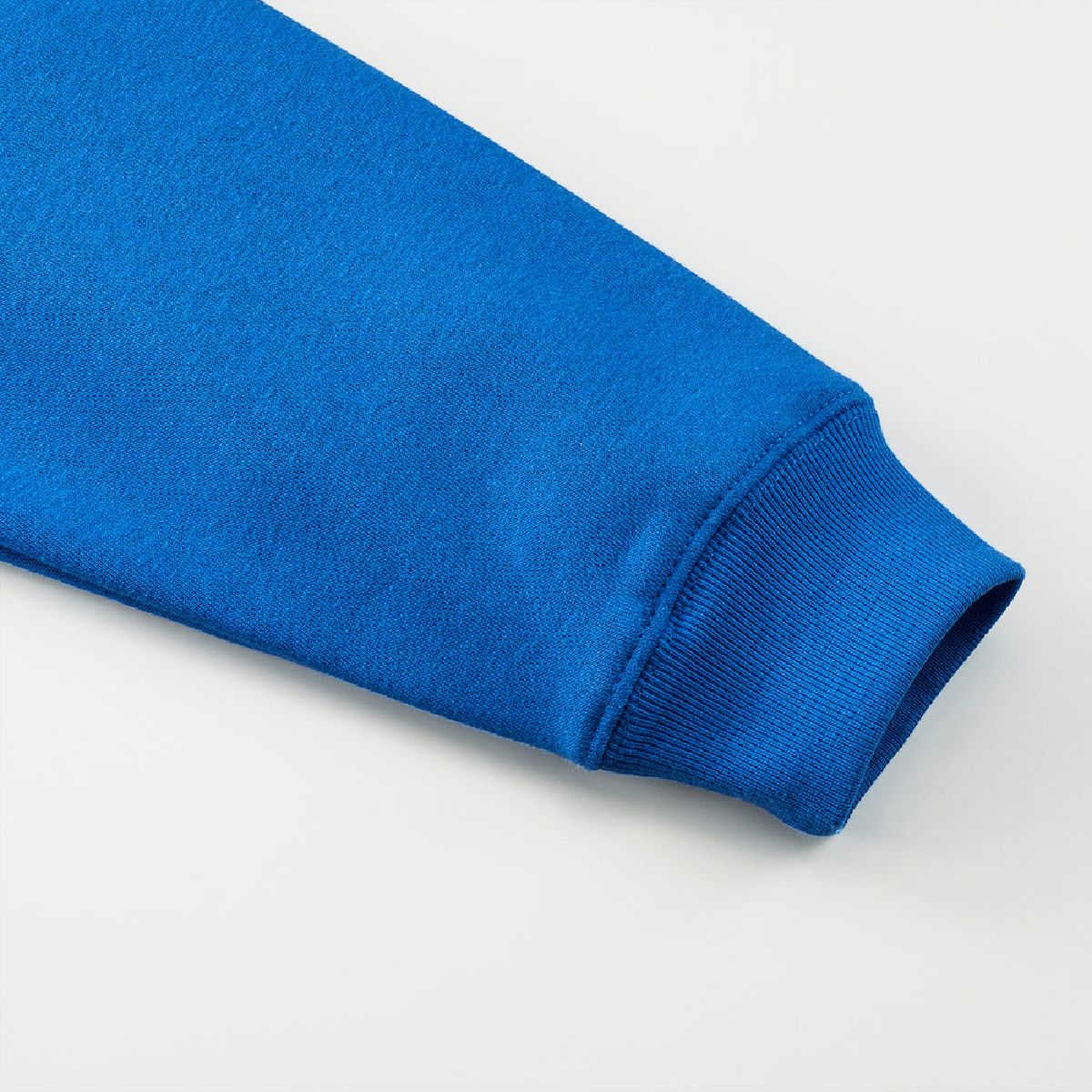 The cuffs are ribbed, and the seams are finished with a robust double-needle stitching.