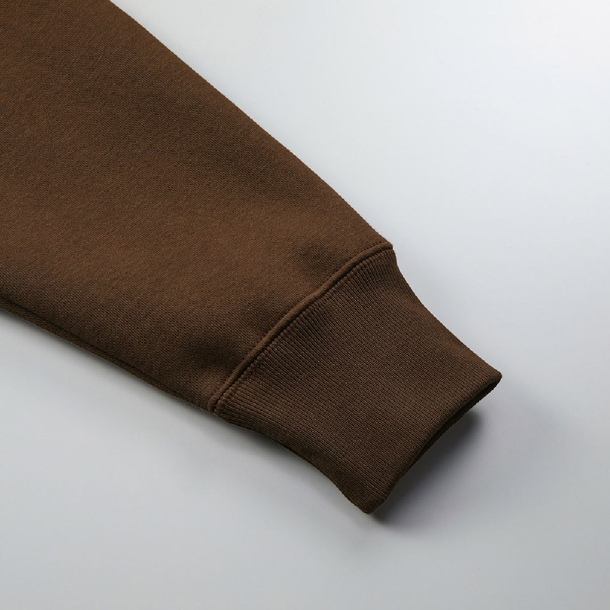 The ribbed cuffs and body seams are finished with a robust double-needle stitching.