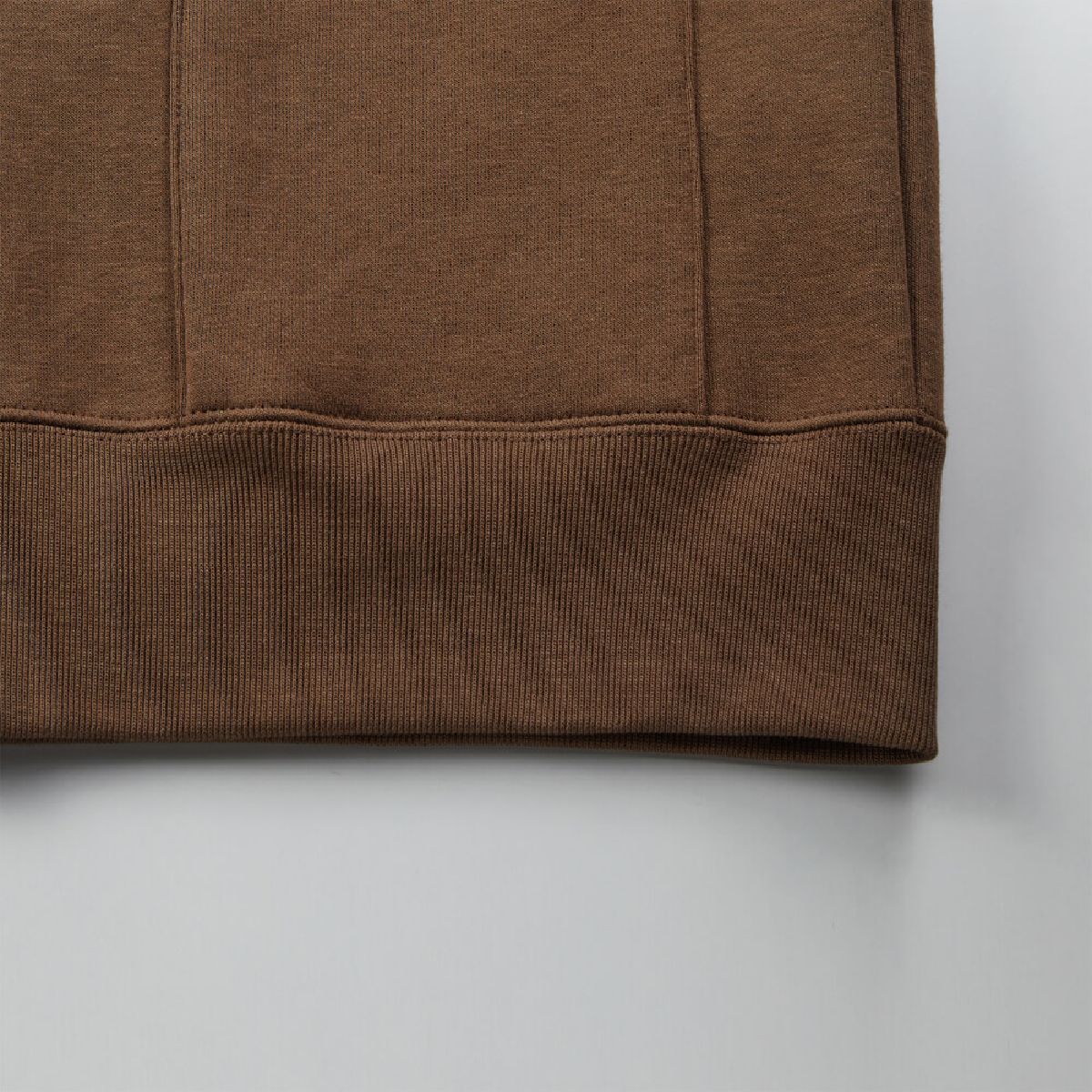 The ribbed cuffs and body seams are finished with a robust double-needle stitching.