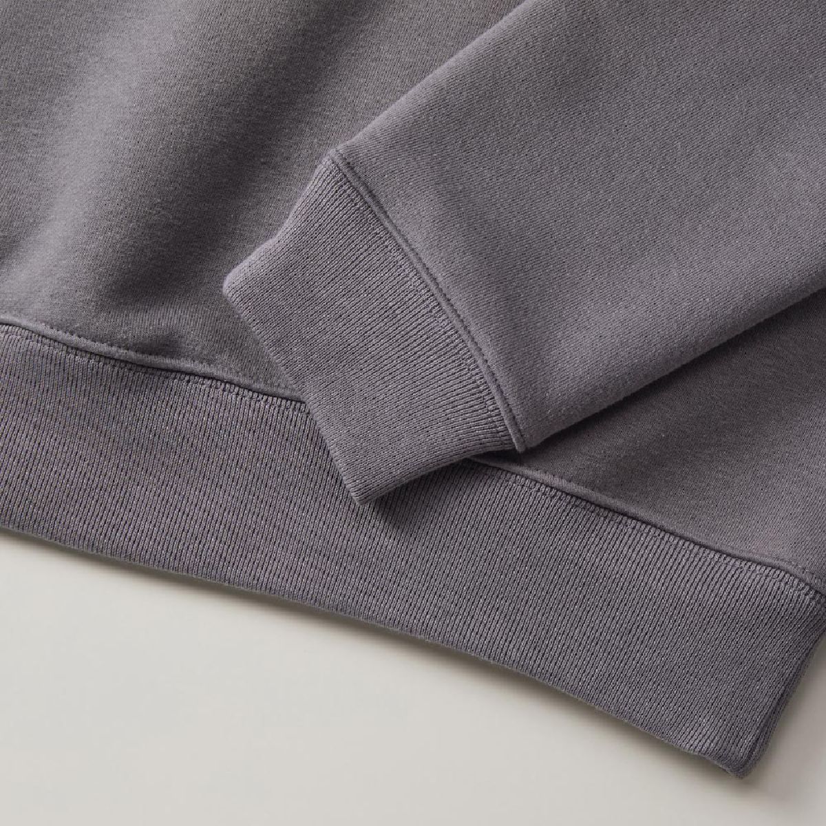 The ribbed cuffs and hem, as well as the seams on the body, are finished with double stitching.