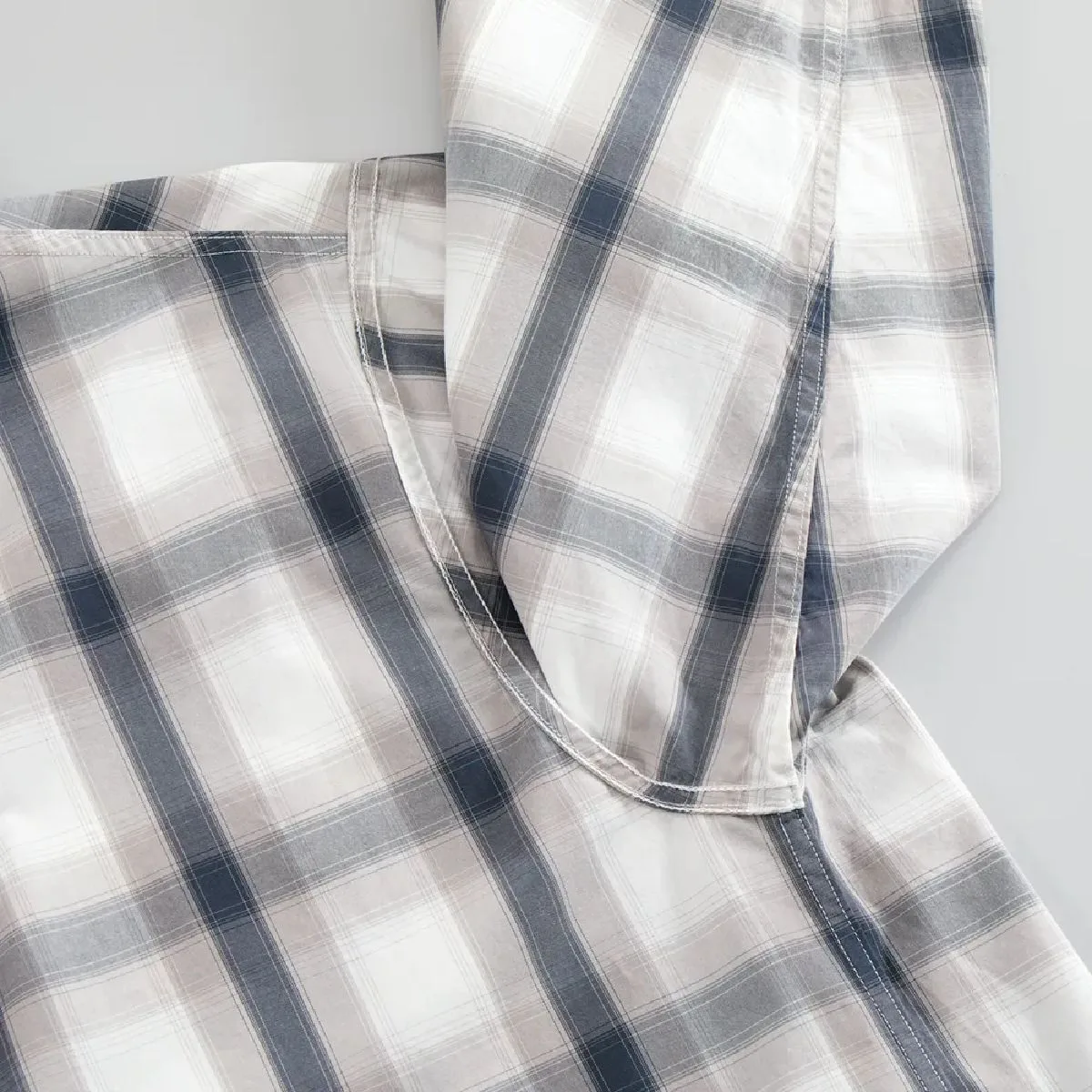 Close-up of the underarm and side seam line when the garment is turned inside out, showing the sturdy flat-felled seam finish.