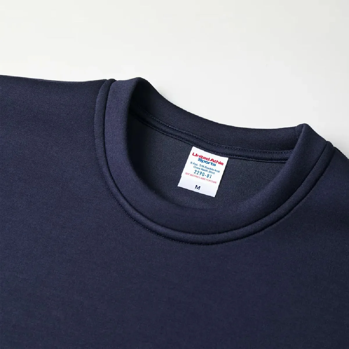 The neckline is made from the same fabric as the body of the garment.