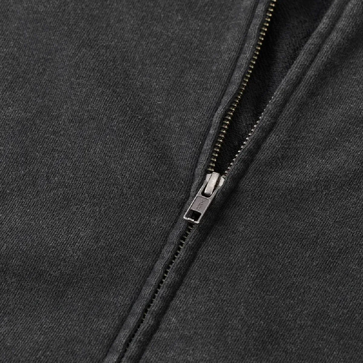 The zipper is concealed, made by YKK, features a single slider, and comes in an antique silver color.