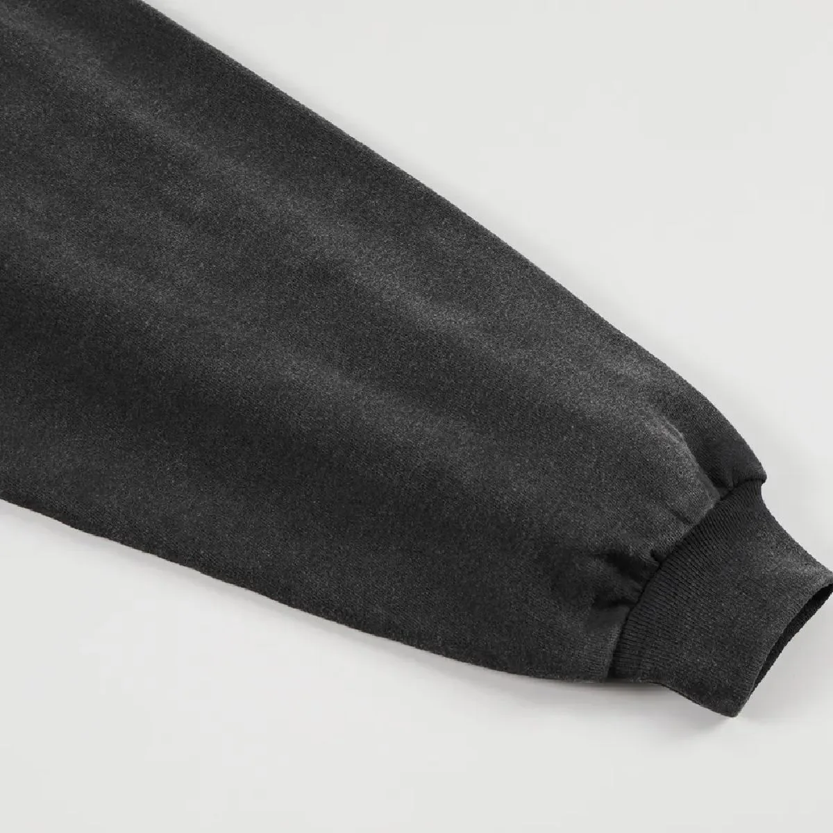 The cuffs are ribbed, and the gathered design gives it a soft, voluminous look.