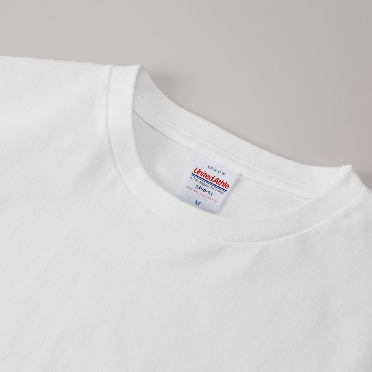 The neck ribbing features a minimalist, stitch-free design.