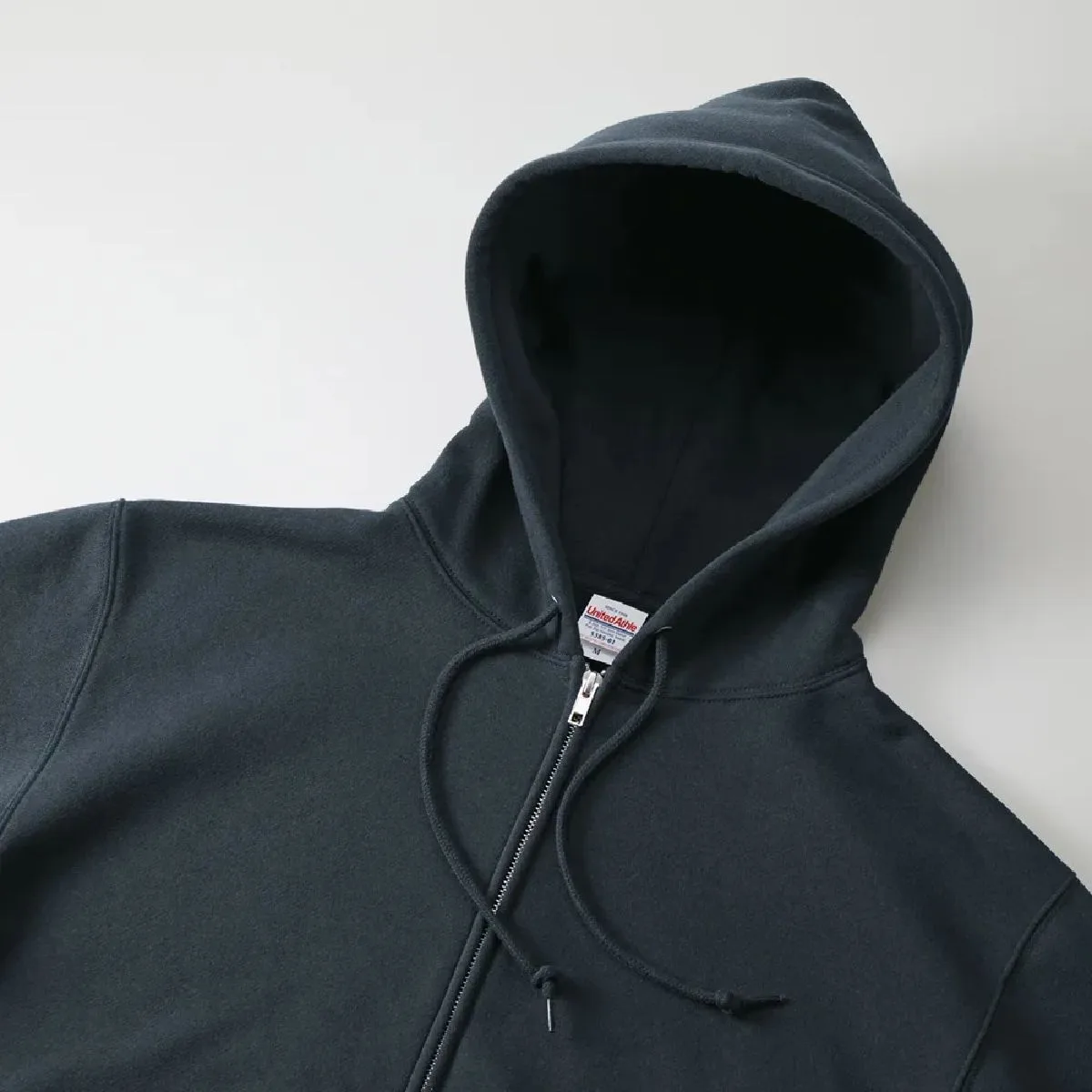 It features a double hood with a three-dimensional design.