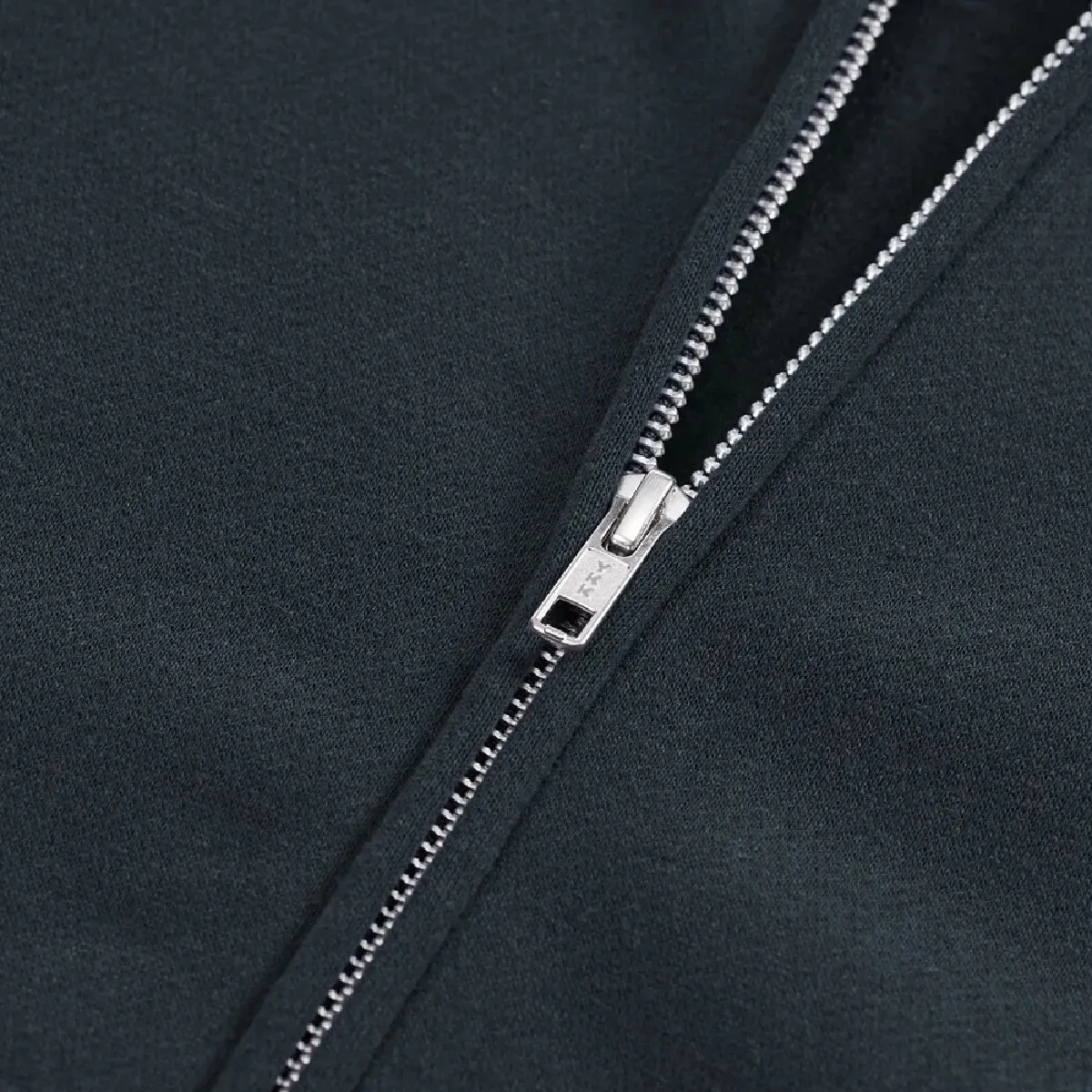 The zipper is concealed and features a single slider, manufactured by YKK.