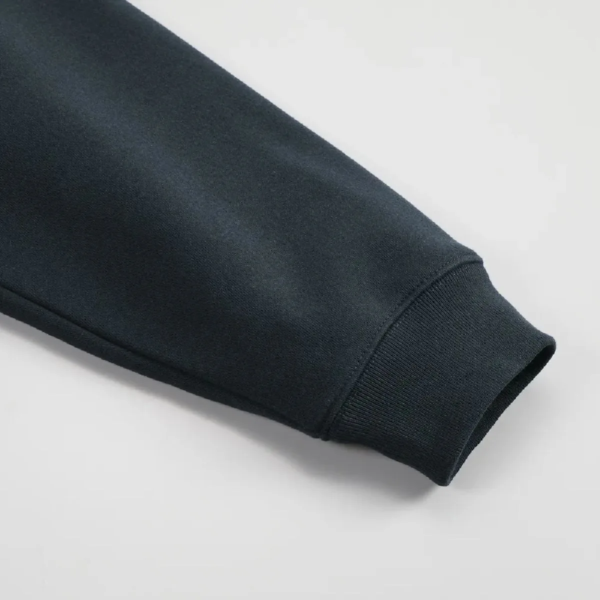 The cuffs are ribbed, and the seams are finished with a robust double-needle stitching.
