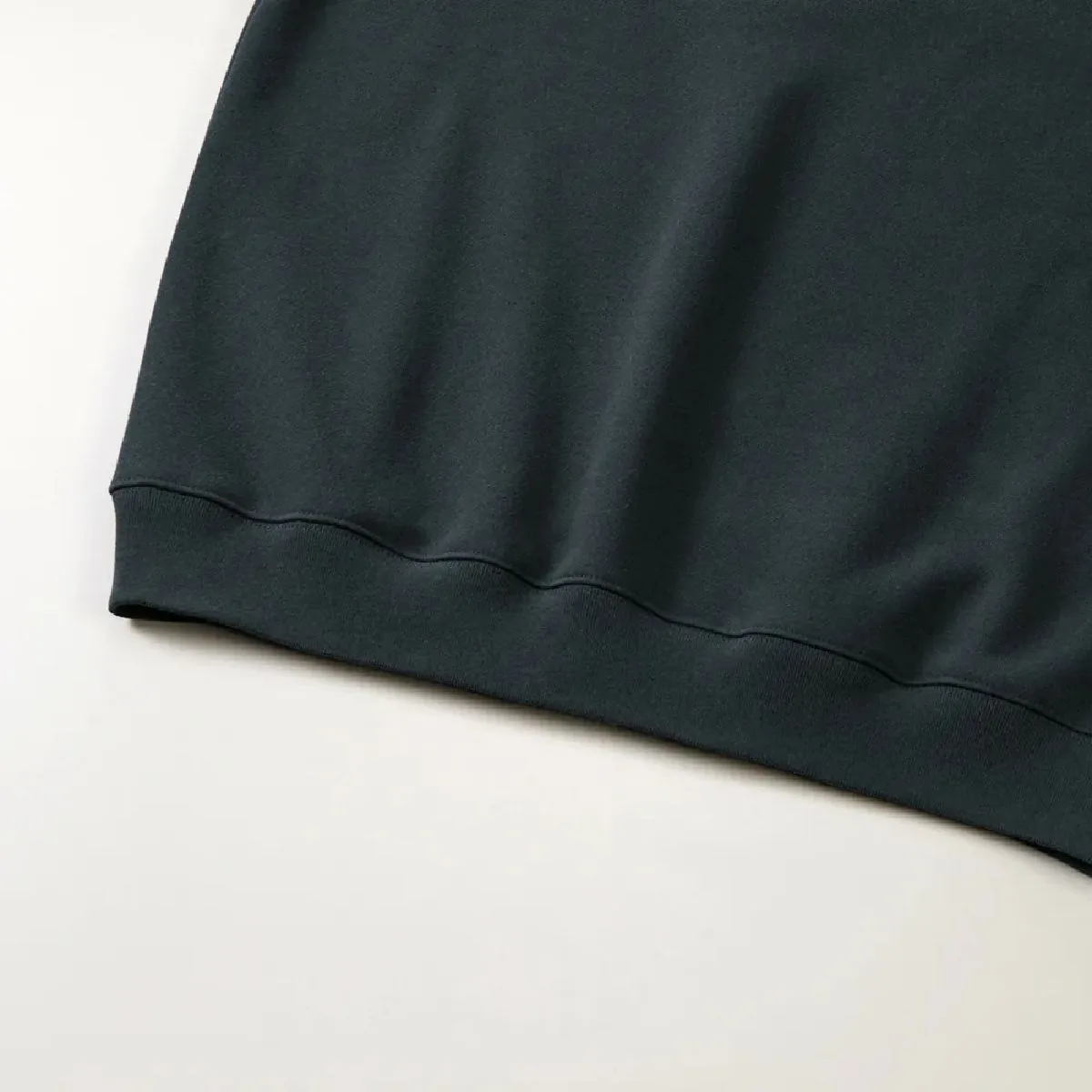 The ribbed hem and body seams are finished with a sturdy double-needle stitch.
