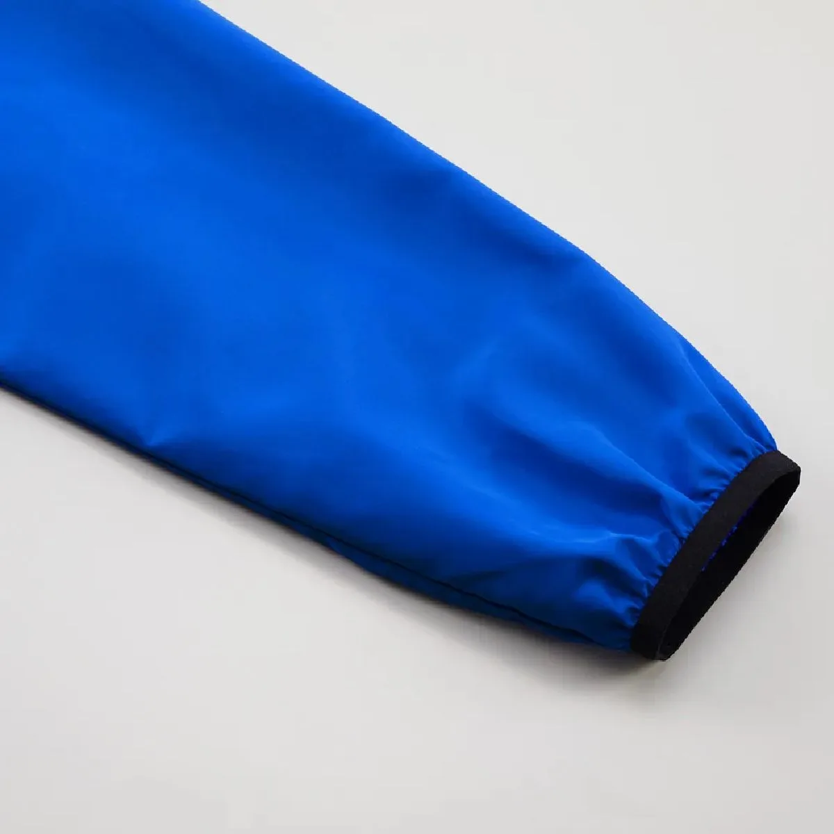 The cuffs feature stretch tape piping for a snug fit around the wrists.