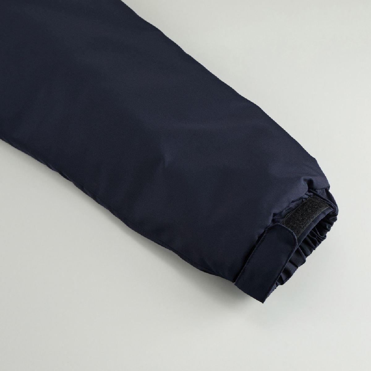 The cuffs have shirring and hook-and-loop fasteners.