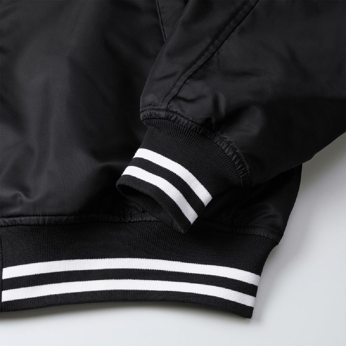 The cuffs and hem have a fitted ribbed design, and Color No. 2001 and 4001 feature a striped rib finish.